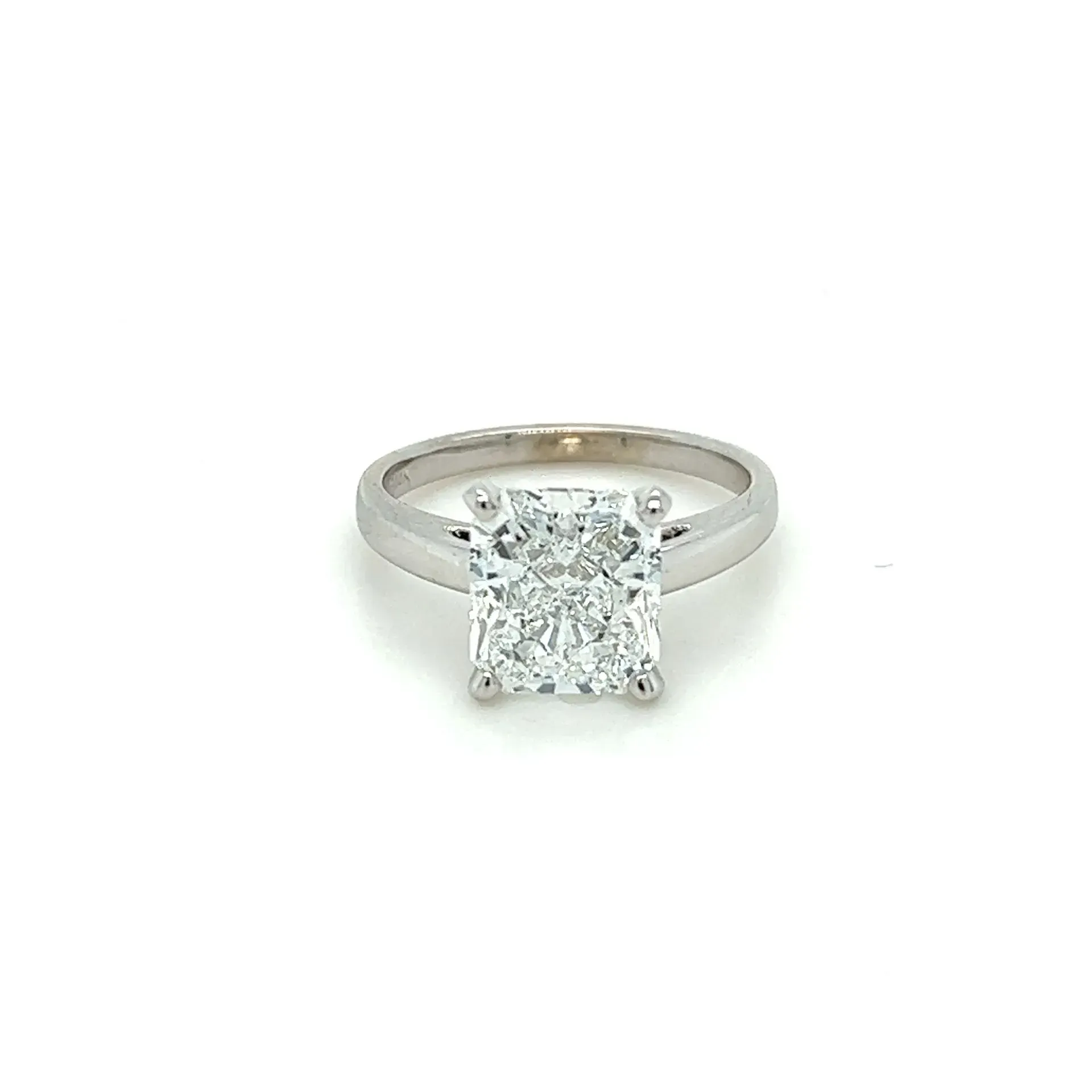 A white gold ring with a square diamond in the center.