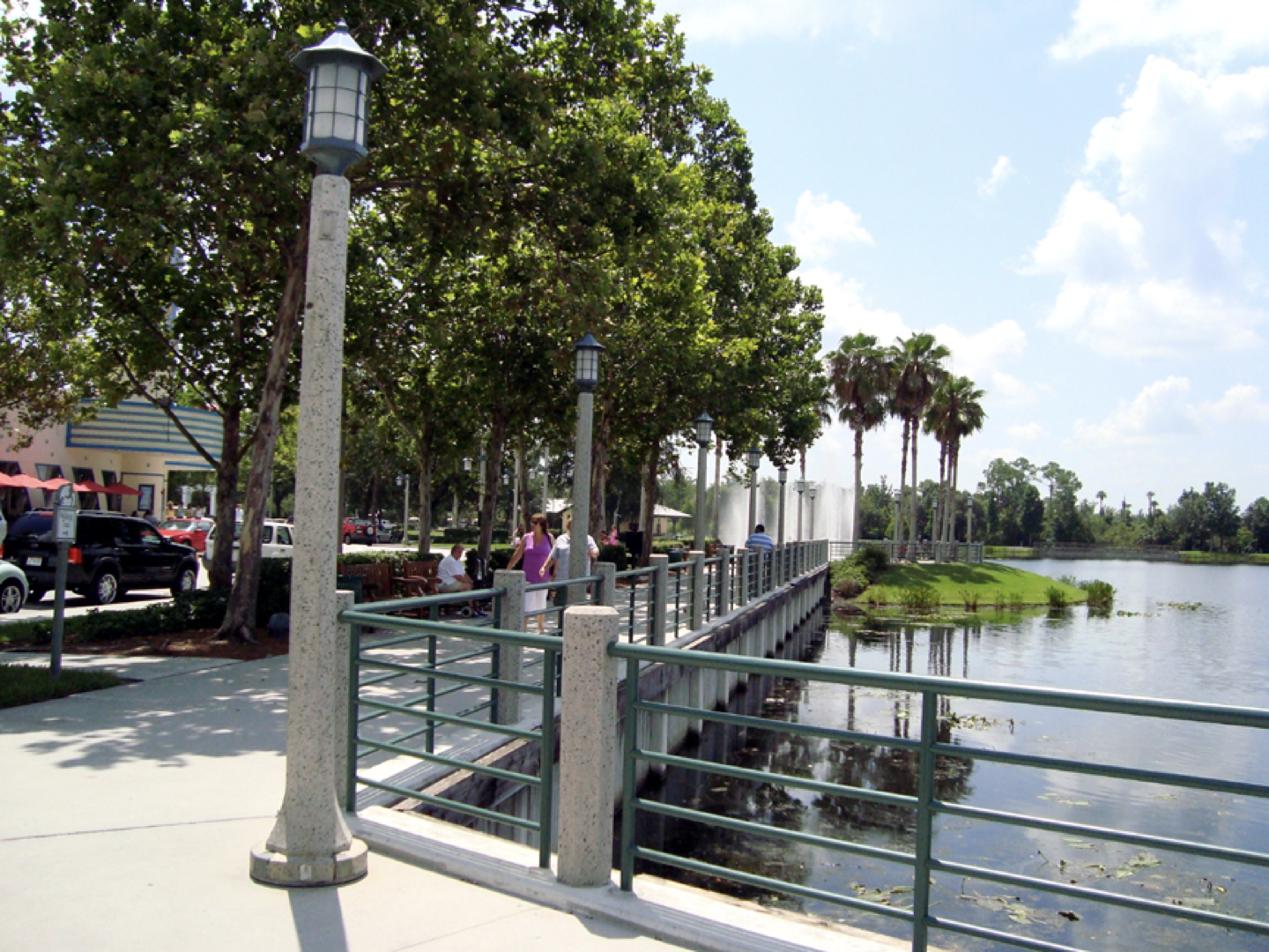 a bridge over a body of water with palm trees in the background