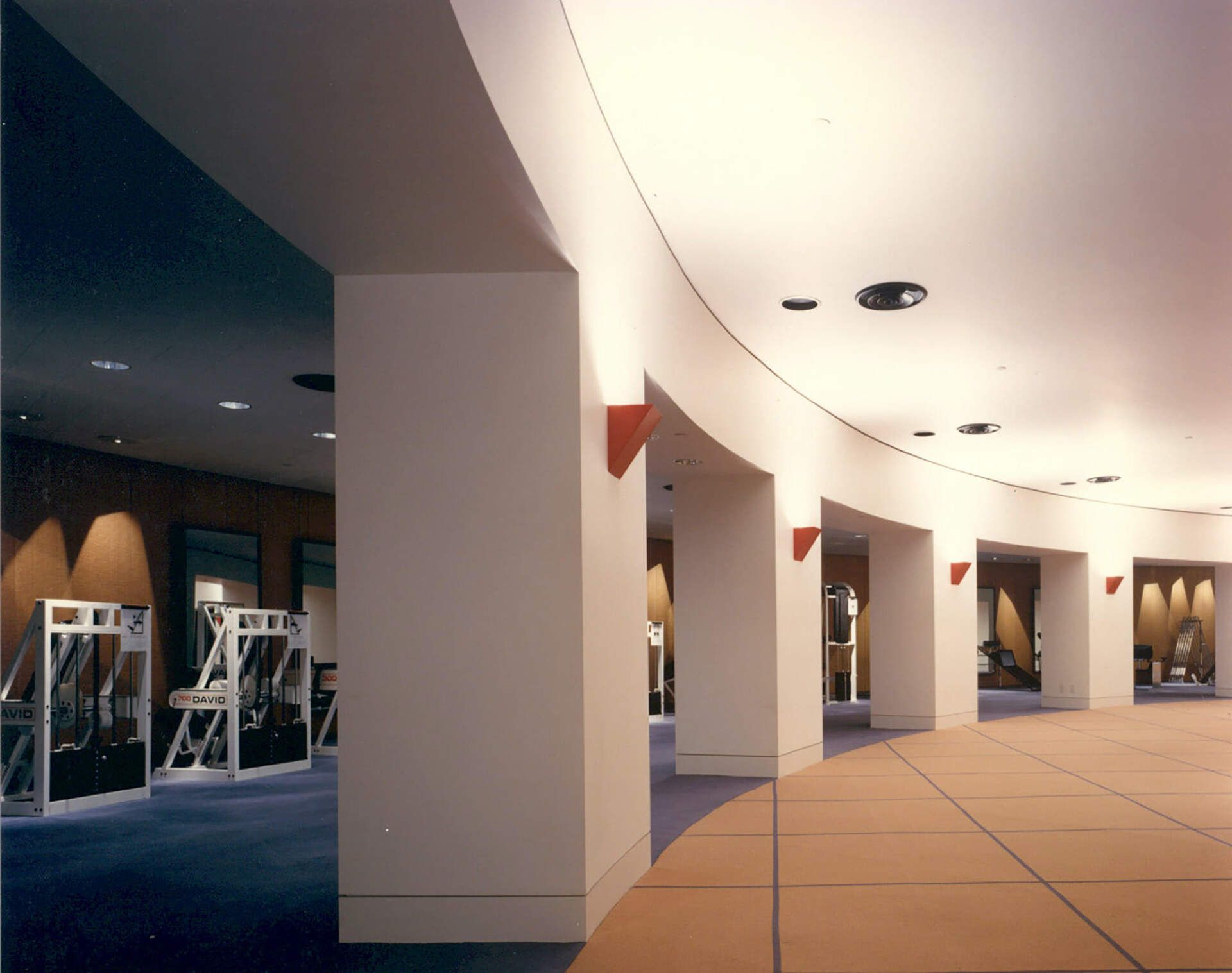 a large room with a lot of columns and a blue carpet
