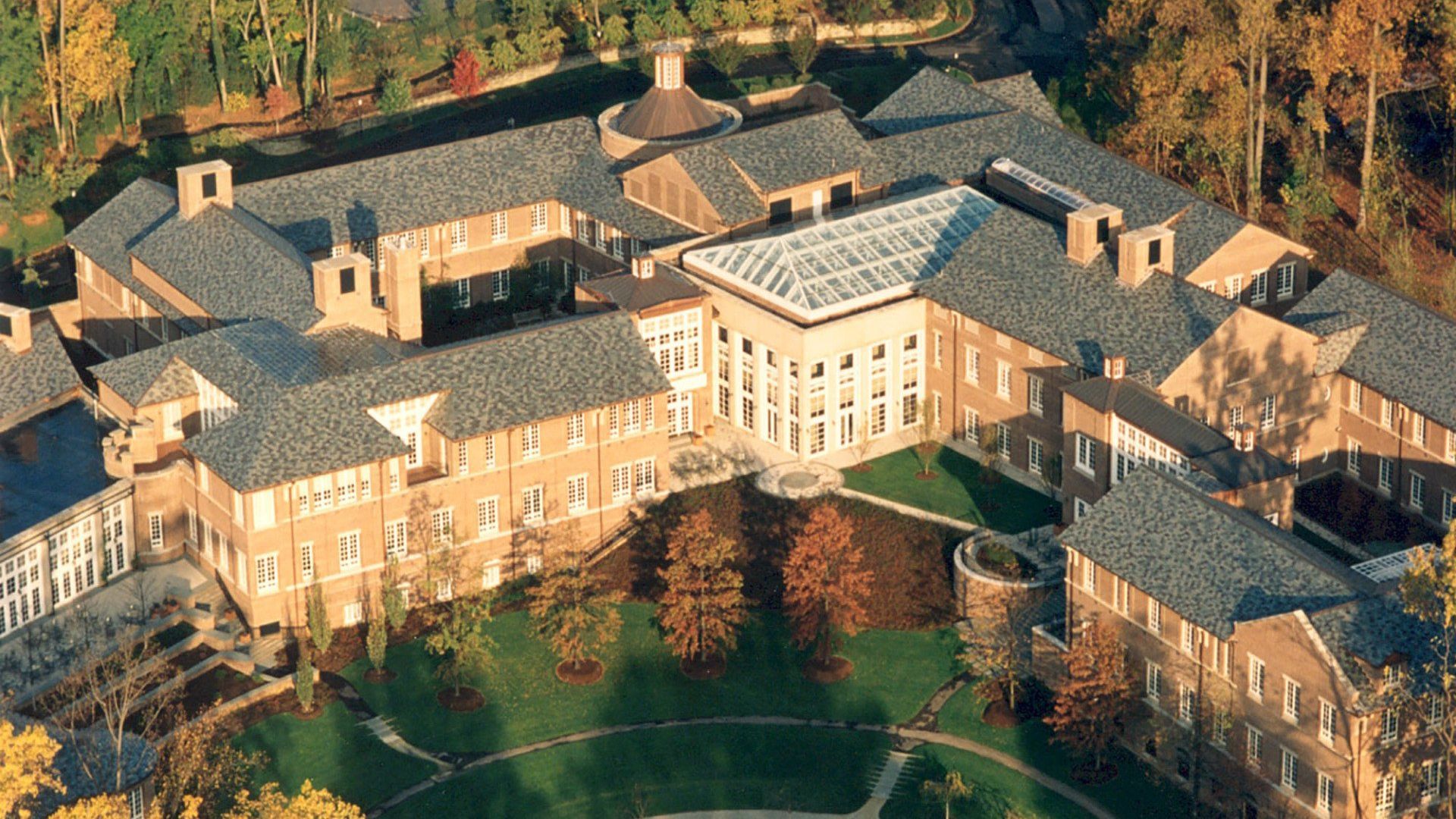 an aerial view of a large building surrounded by trees