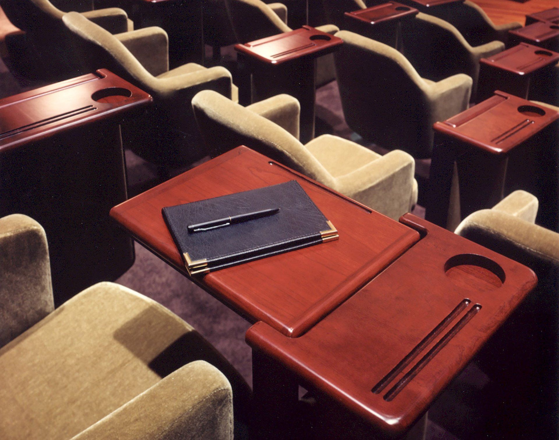 a wooden table with a notebook and pen on it