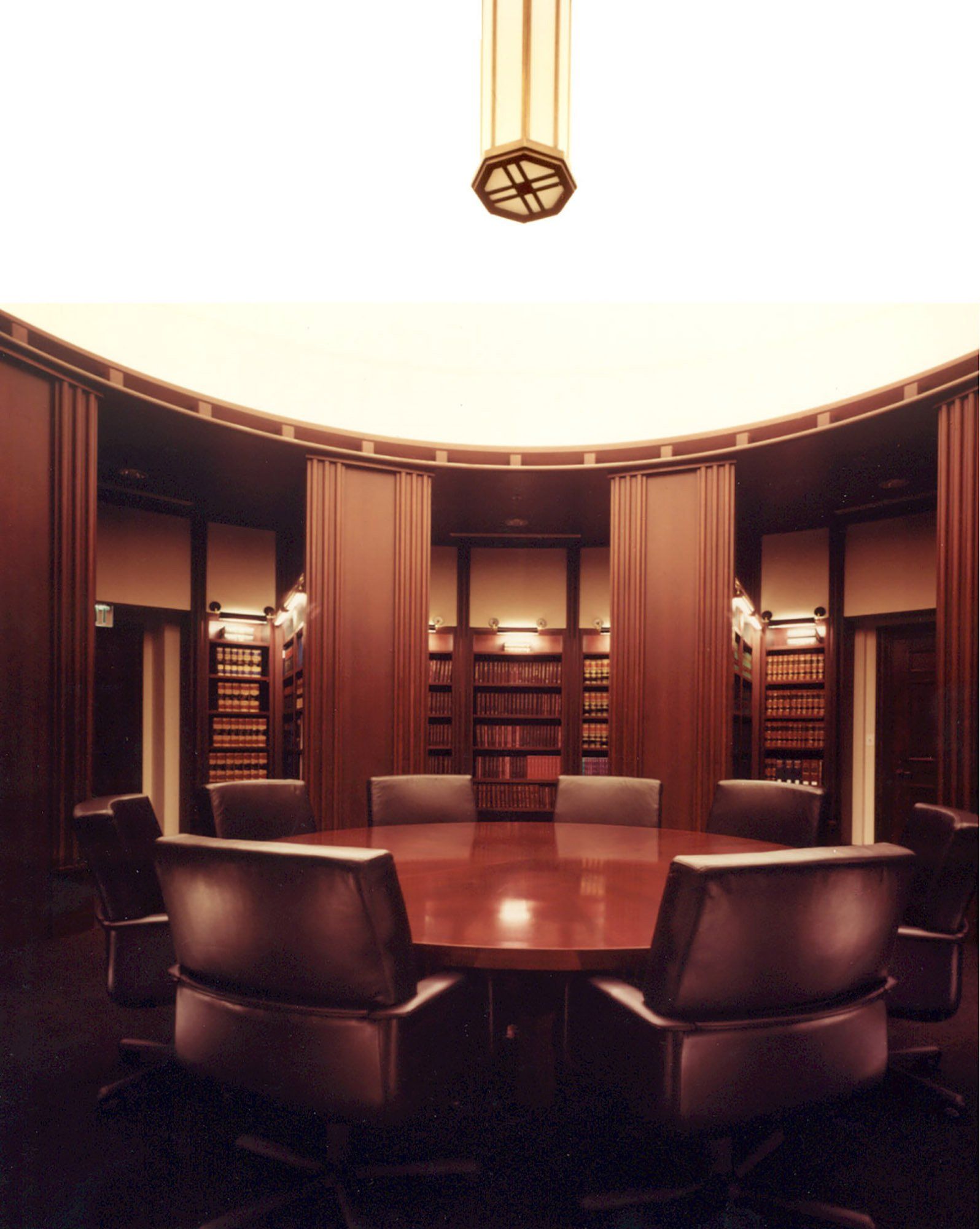 a conference room with a round table and chairs