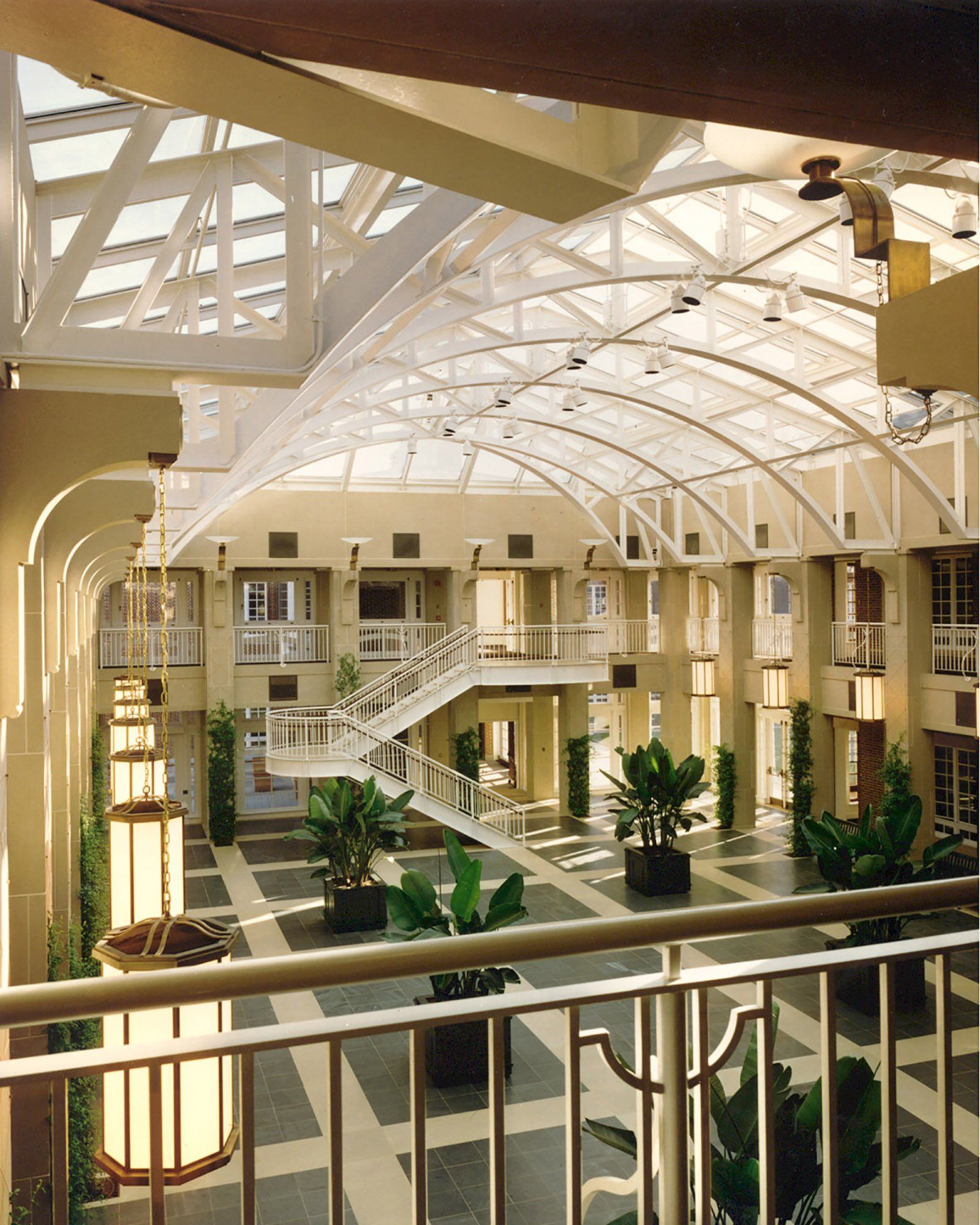 a large building with lots of windows and plants