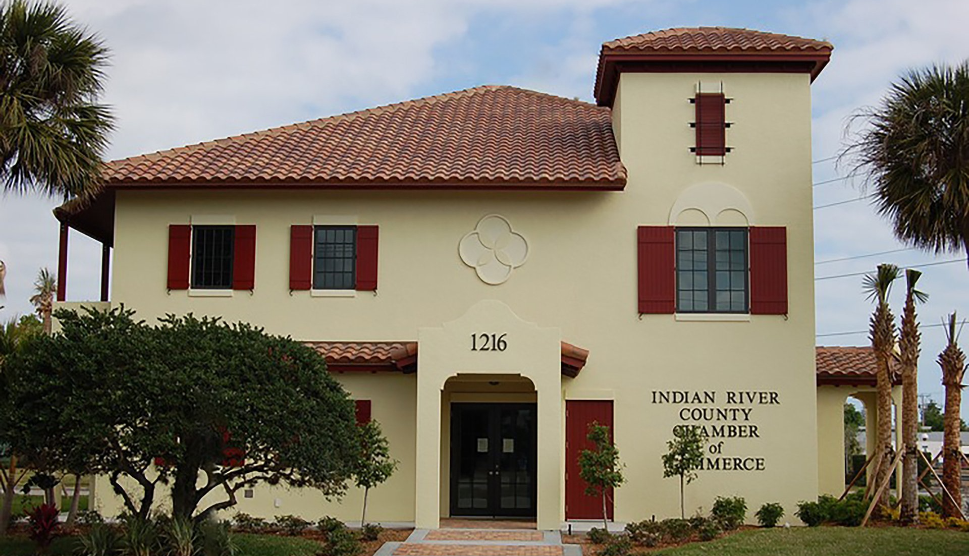 a large house with a clock on the front of it