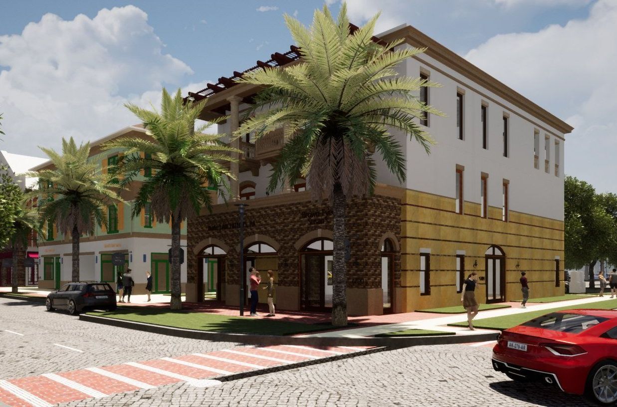 a red car is parked in front of a yellow and white building