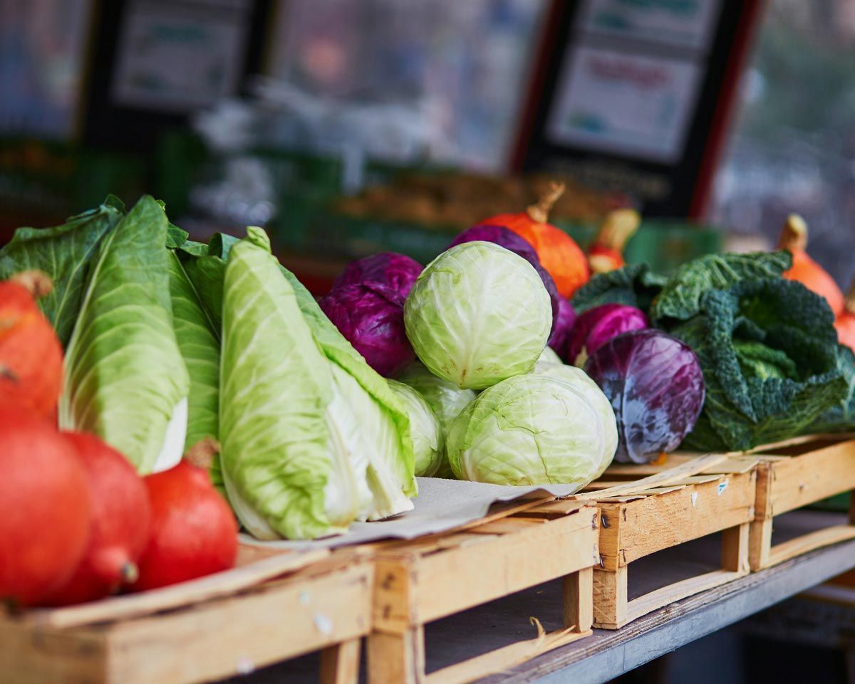 A variety of vegetables are displayed on a wooden crate.