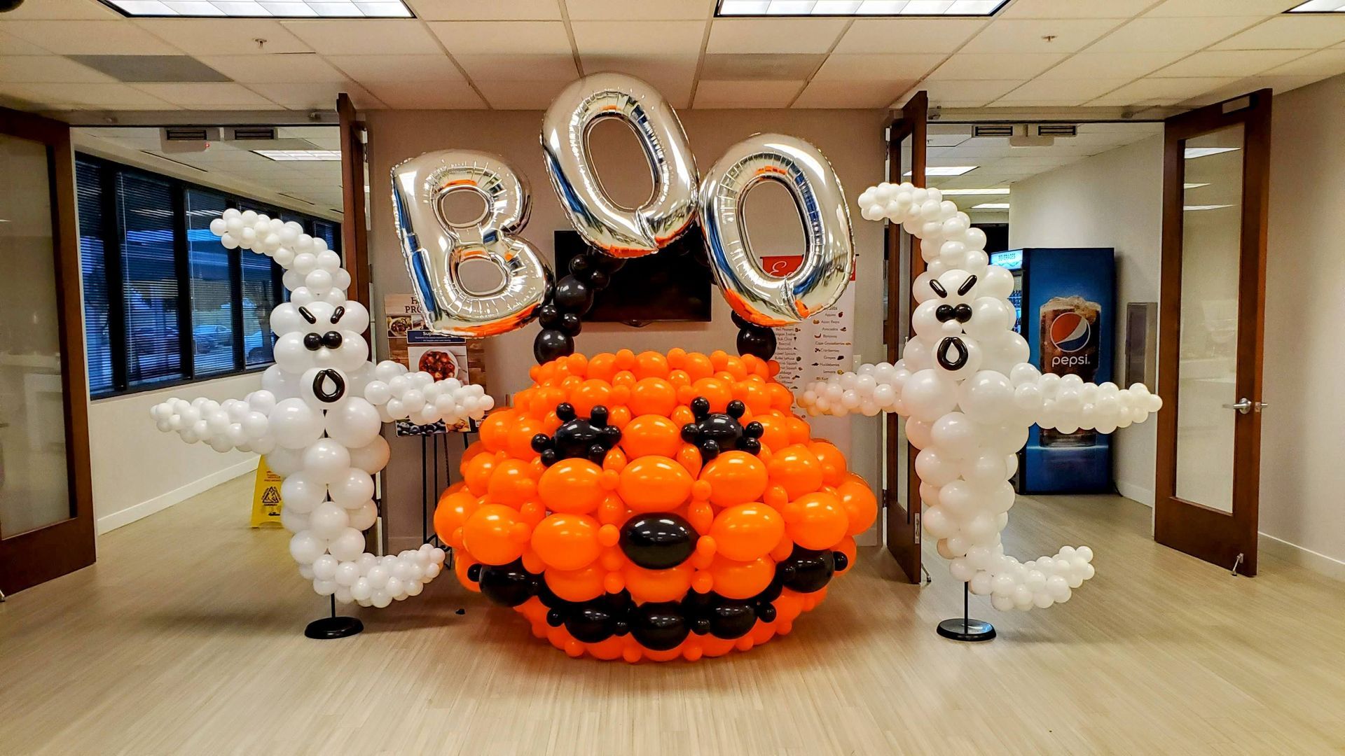 Halloween balloon décor featuring a large pumpkin balloon display with spooky accents for seasonal events