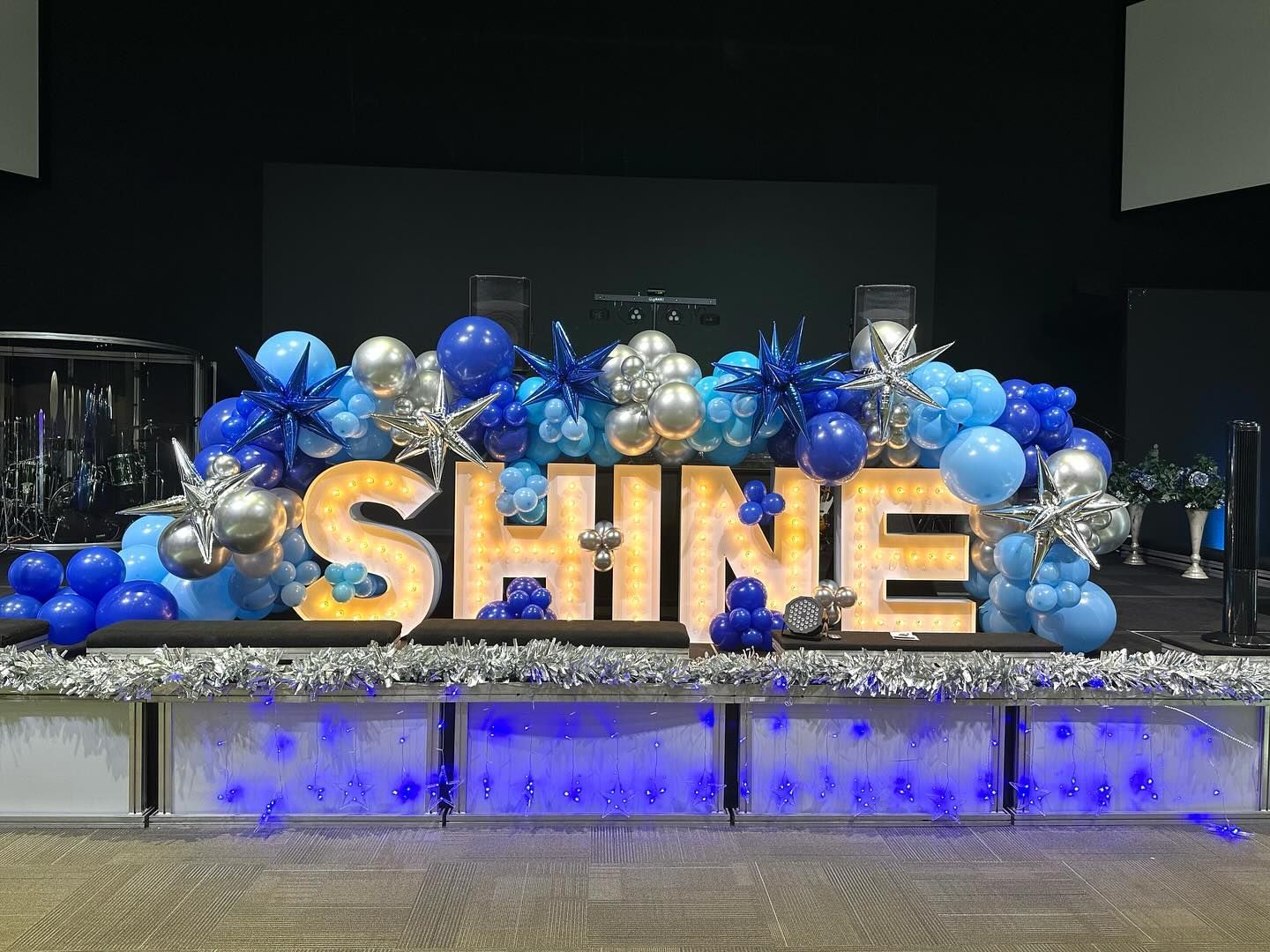 Marquee letter backdrop with balloon garland for custom event display in Fort Worth Texas