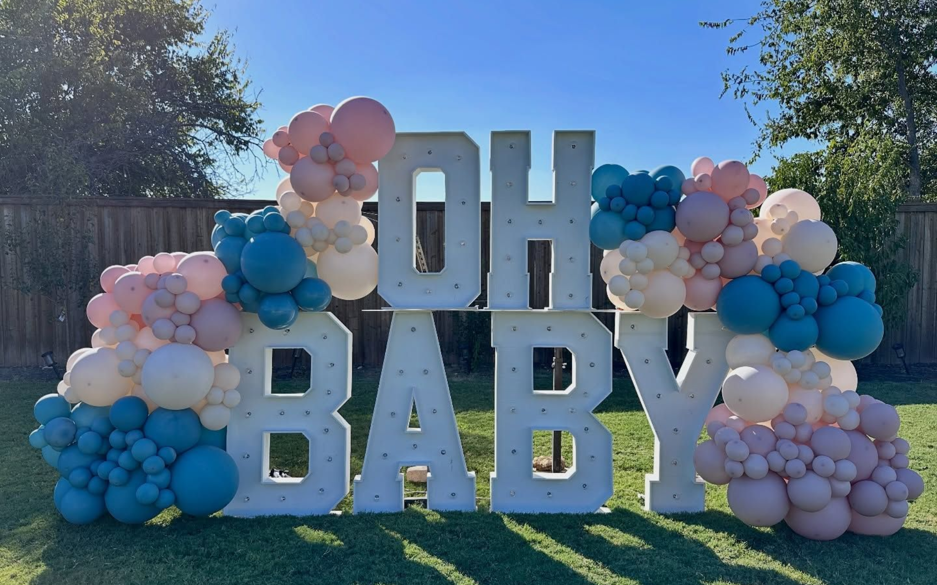 Light up marquee letters OH BABY with pastel balloon decor for baby shower setup in Fort Worth