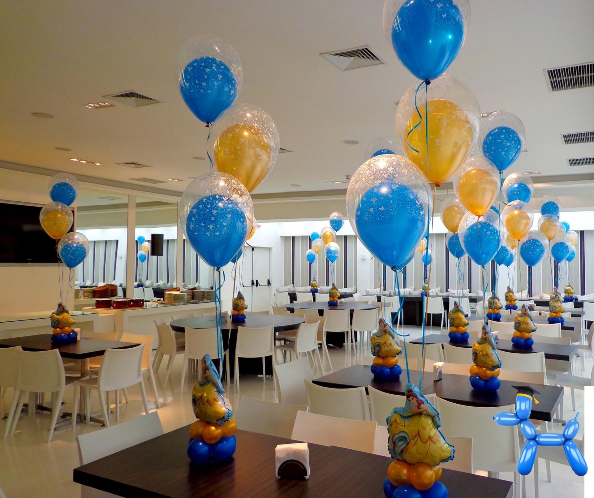 Double stuffed helium balloon centerpieces in yellow and blue sitting on tables for a celebration.