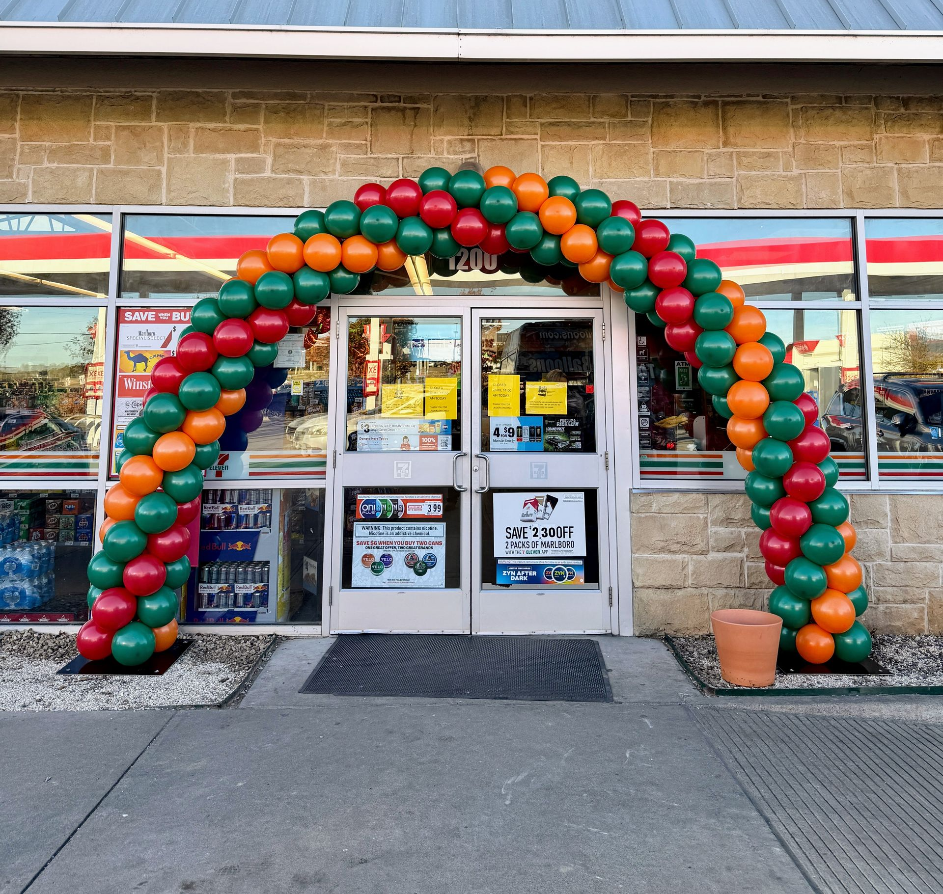 Grand opening balloon arch installation at retail storefront for business ribbon cutting event