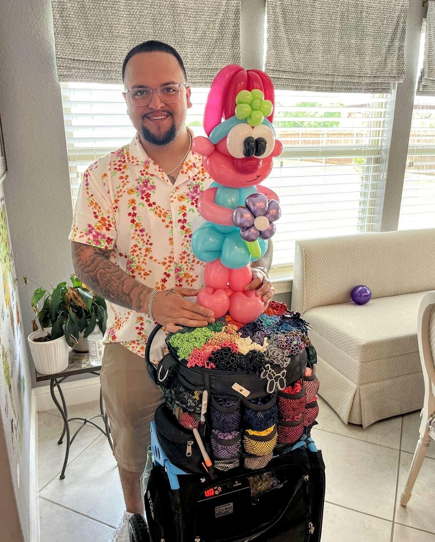 A man is standing next to a bag filled with balloons.