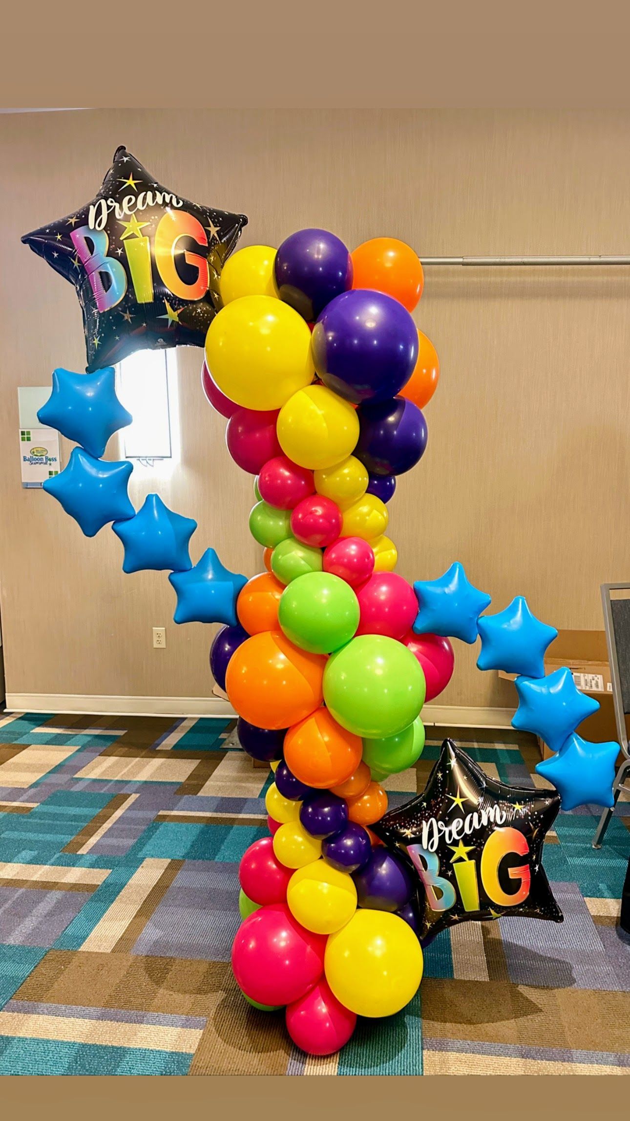 Large balloon column with vibrant colors and star balloons, designed for school events,  and back to school celebrations