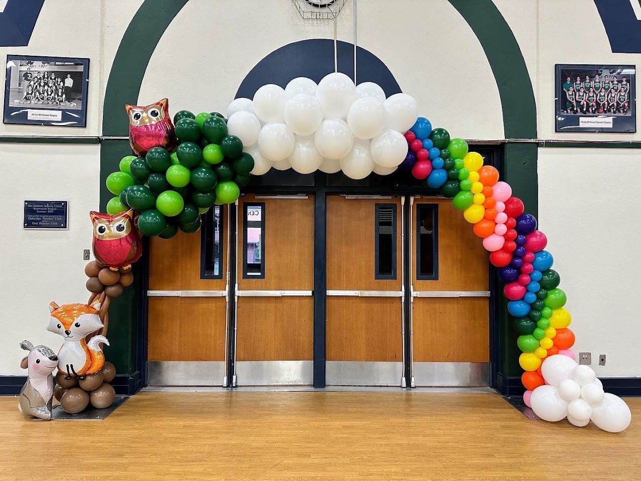 A back to school backdrop with red, blue, and colorful balloons with crayons and letter foils.