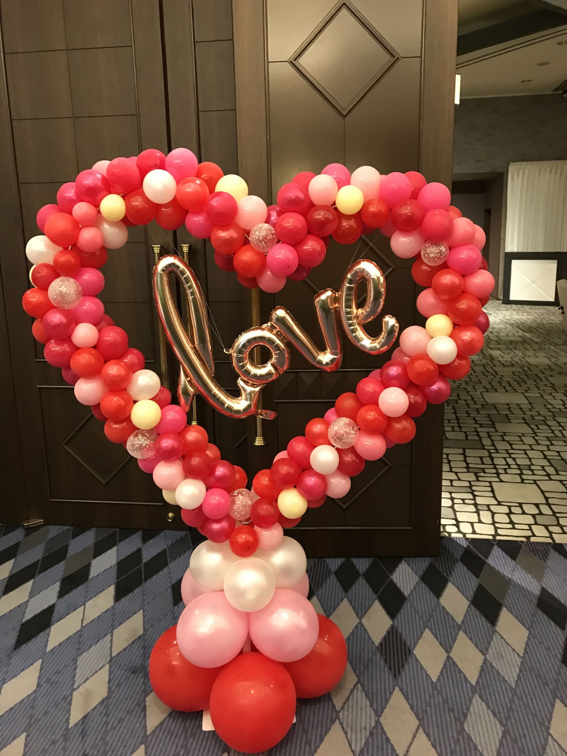 A heart made of balloons with the word love on it