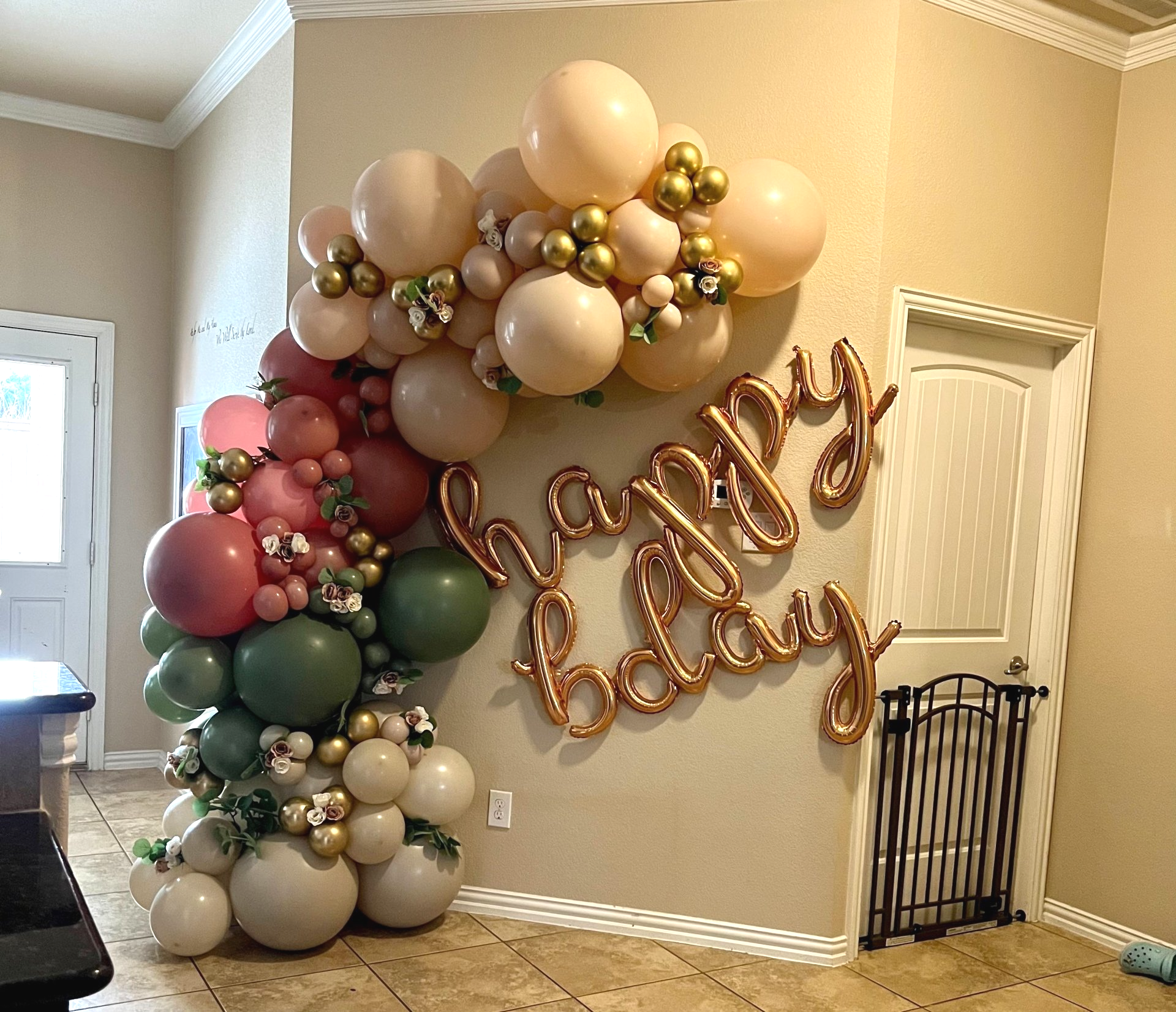 A room filled with balloons and a sign that says `` happy birthday ''.