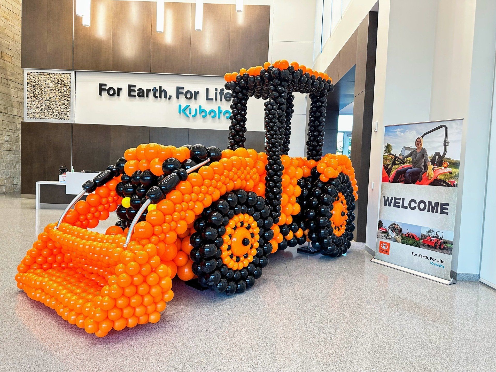 A bulldozer made out of balloons in a lobby