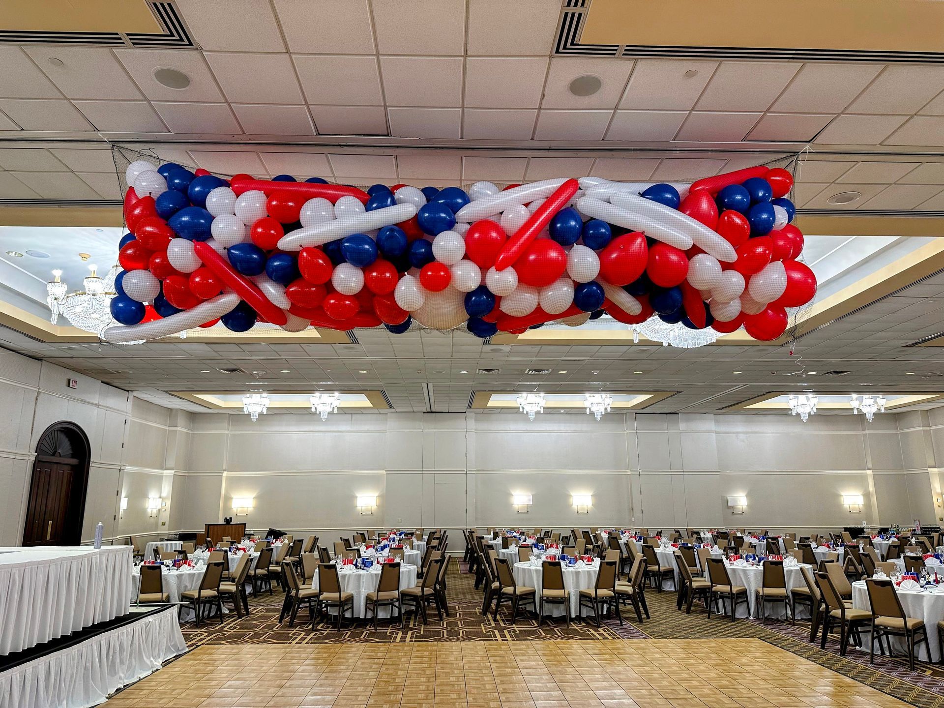 Red, white, blue balloon drop hanging from ceiling. Perfect for Grand opening and corporate events.