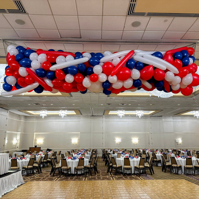 Balloon drop installation with red white and blue balloons for event ceiling decor in Fort Worth DFW