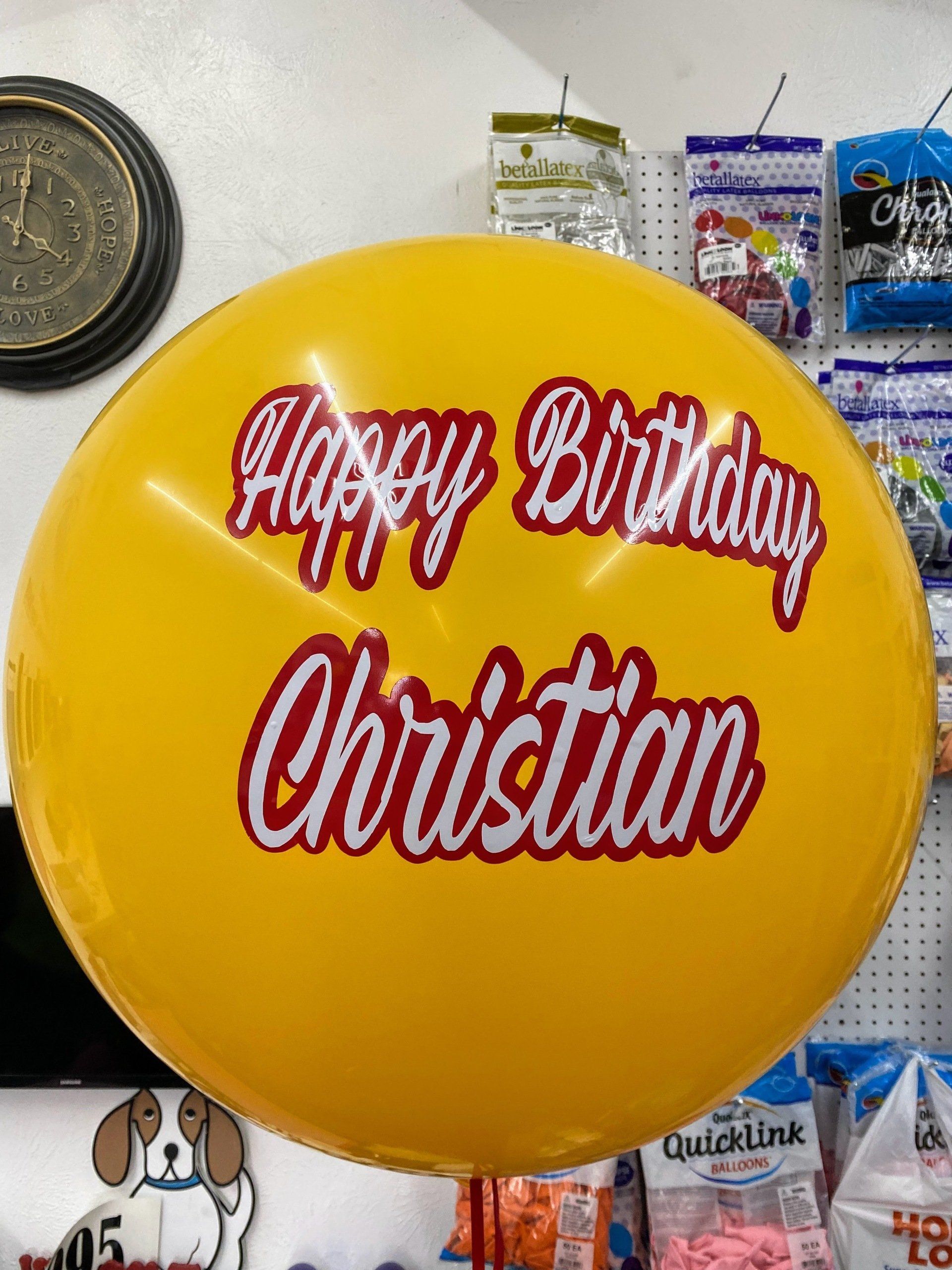 A yellow balloon with the name christian on it