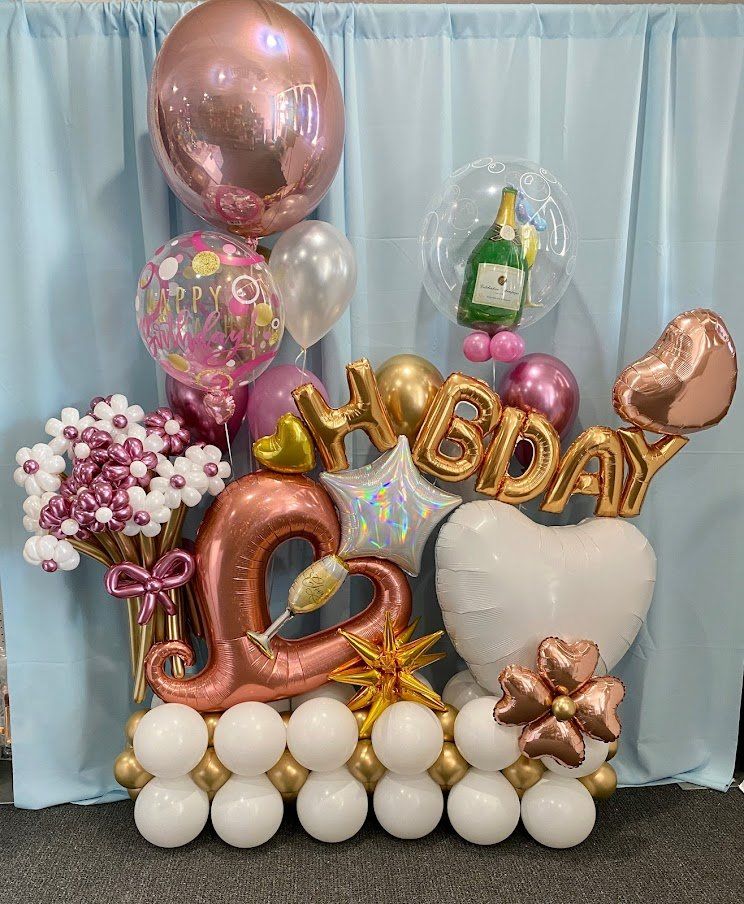 A bunch of balloons are sitting on top of each other on a table.