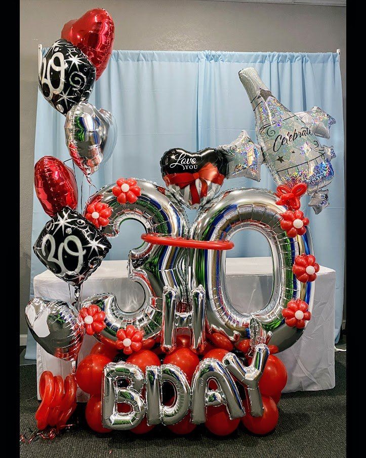 A bunch of balloons are sitting on top of a table.