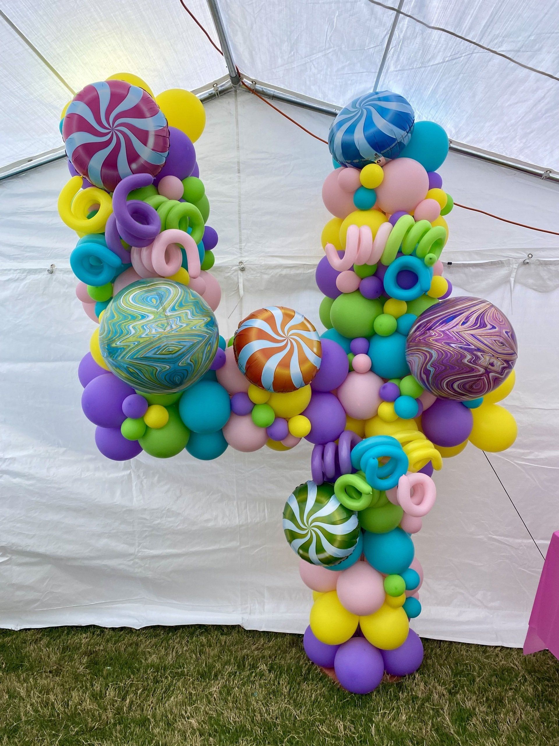 A large number four made of balloons and candies