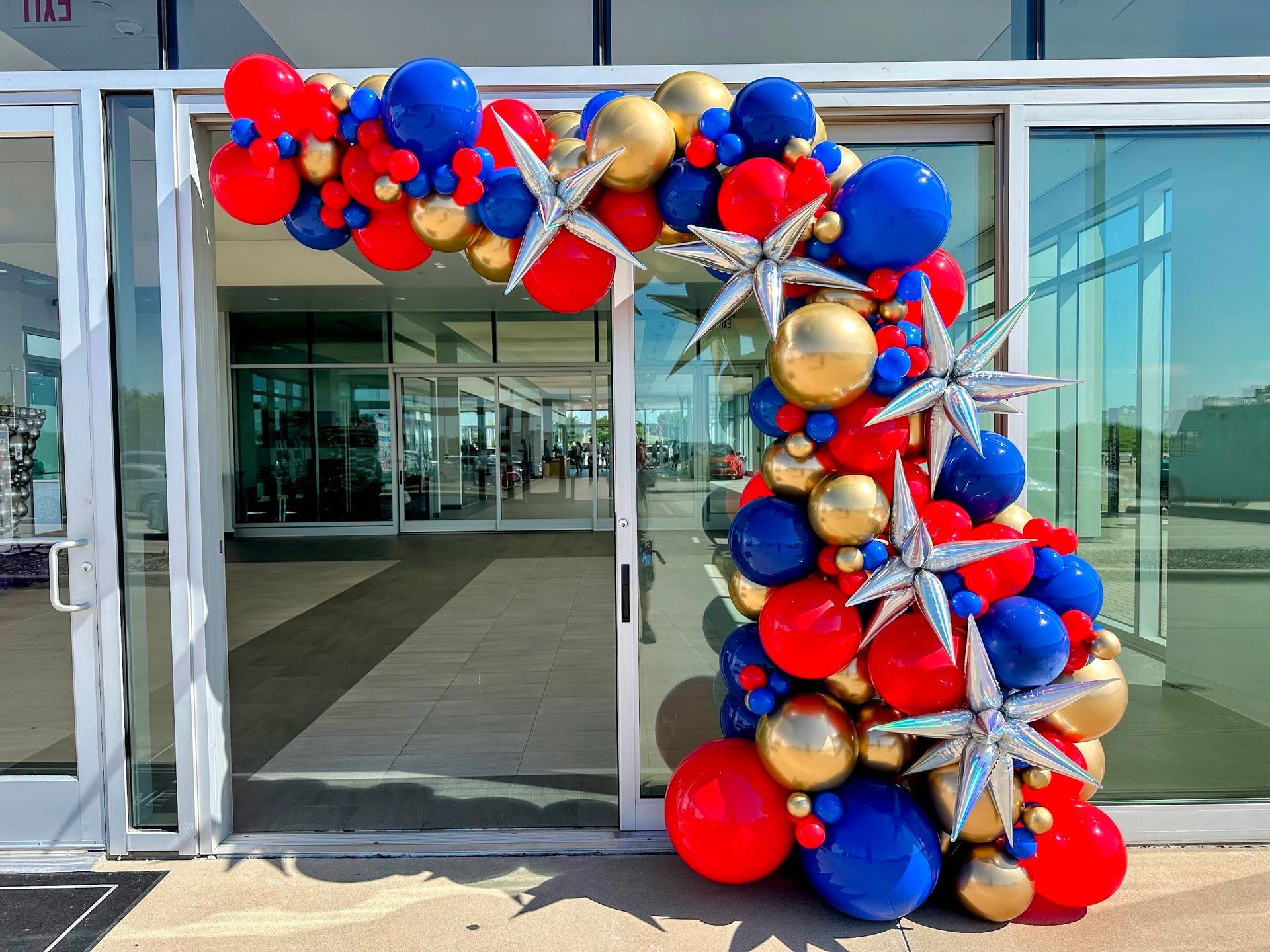 Blue, gold, and red school spirit color balloon garland at the entrance. Great for back to school events.