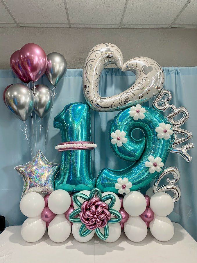 A bunch of balloons are sitting on top of a table.