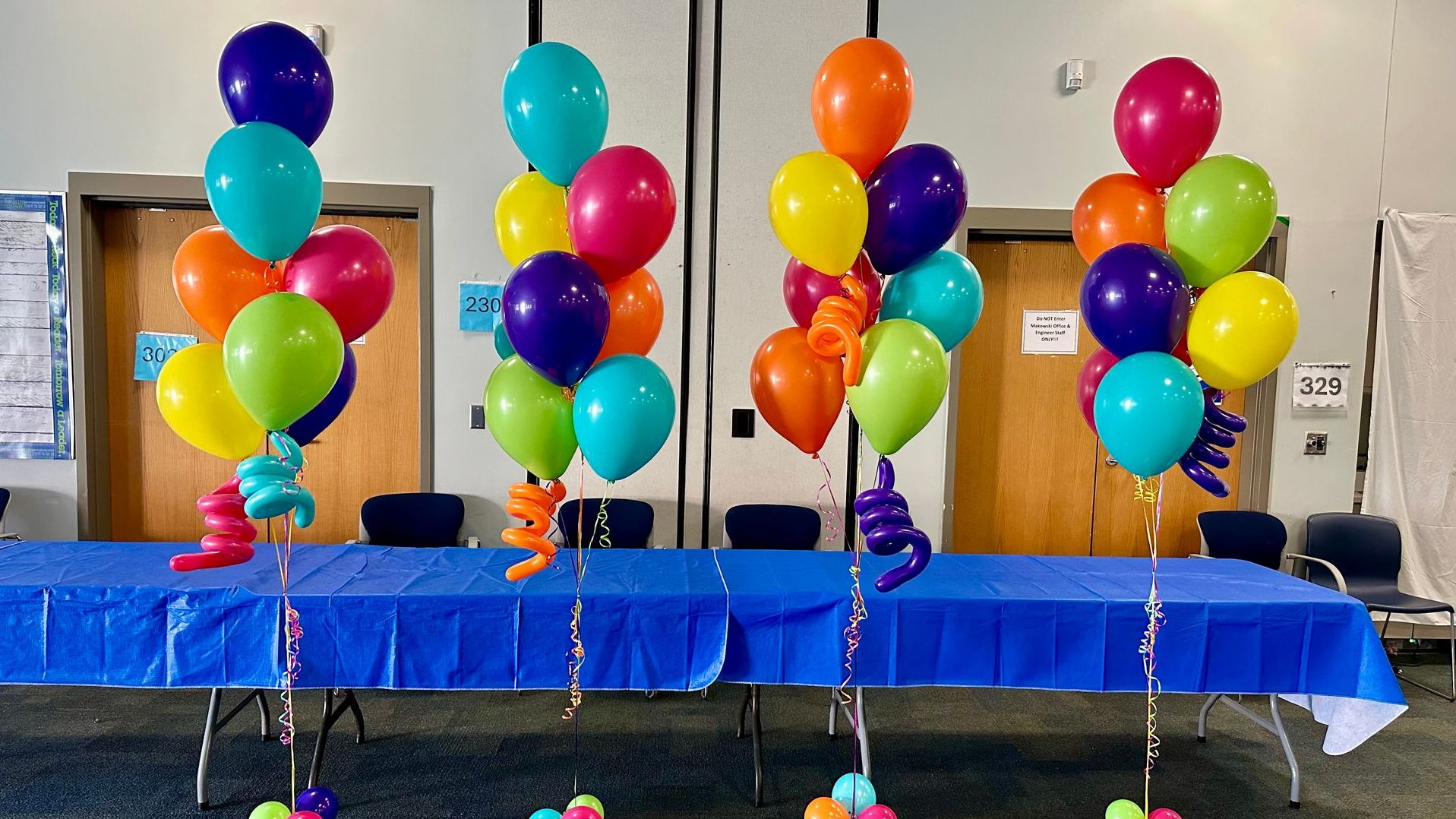 Colorful back to school balloon bouquets in an auditorium. Great for school events and parties