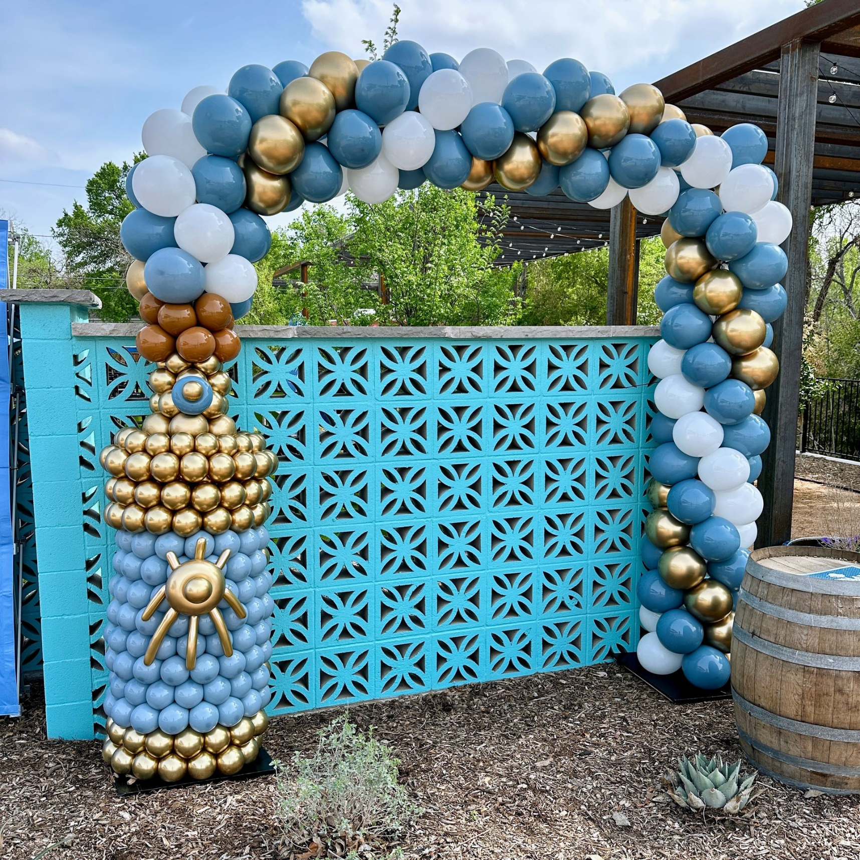 Luxury organic balloon arch with themed decorative balloon column, custom event styling, and premium balloon decor installation.