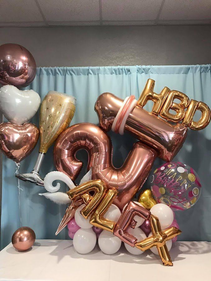 A bunch of balloons are sitting on top of a table.