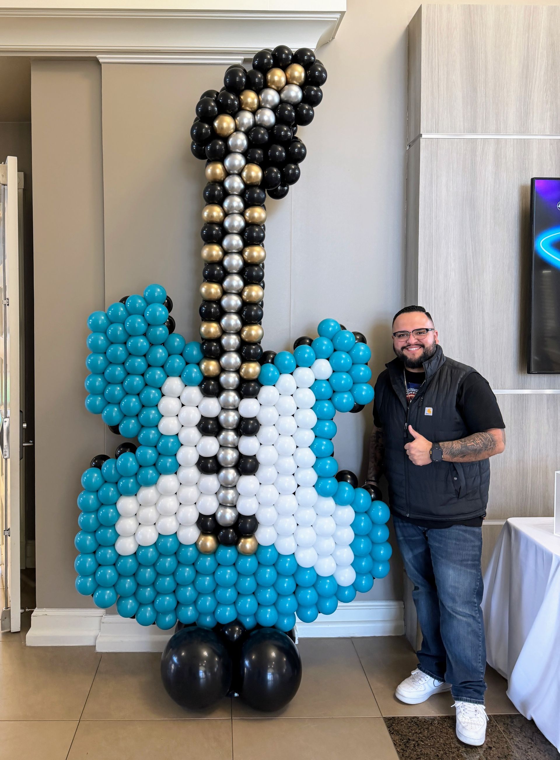 Custom guitar balloon sculpture created for a music-themed event in Fort Worth, featuring detailed balloon artistry and large-scale balloon decor.