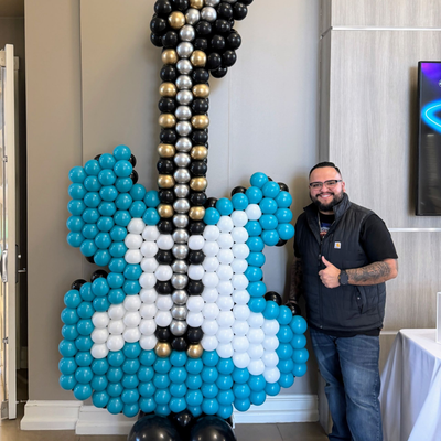 Custom balloon sculpture of a guitar design for themed party decor in Fort Worth Texas