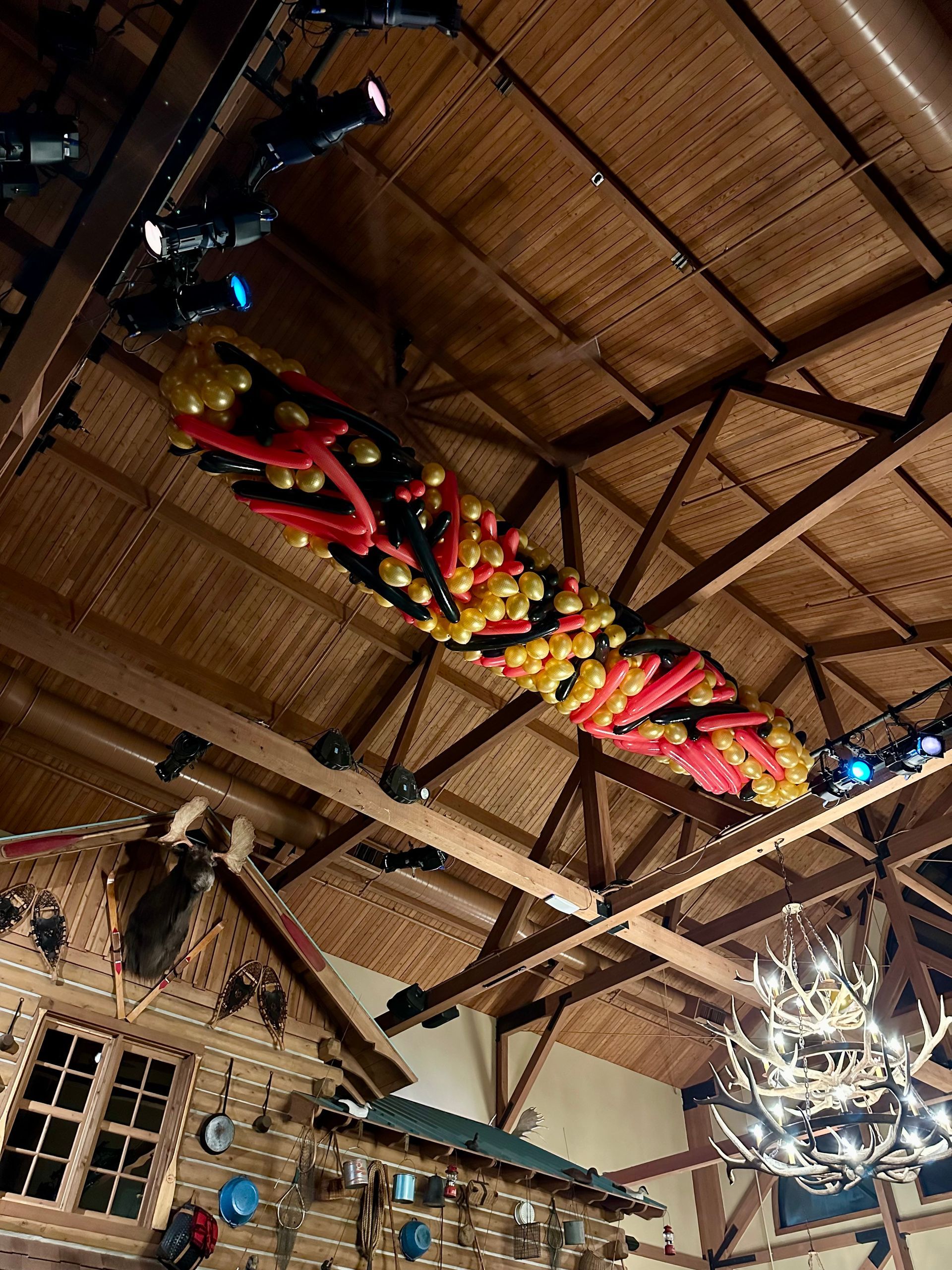 30 foot colorful balloon drop installed in a high ceiling event space