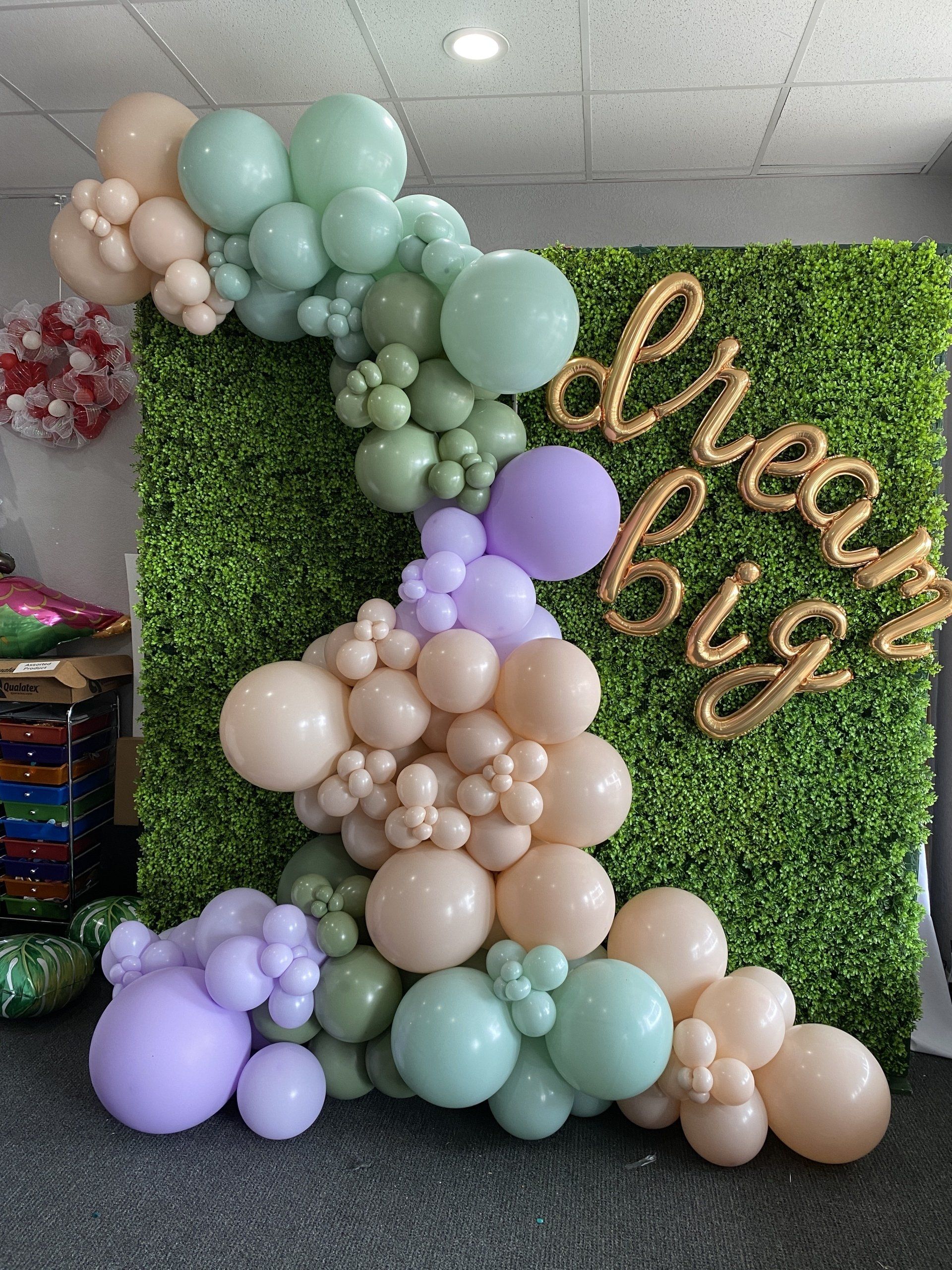 A wall of balloons with the words `` dream big '' written on it.