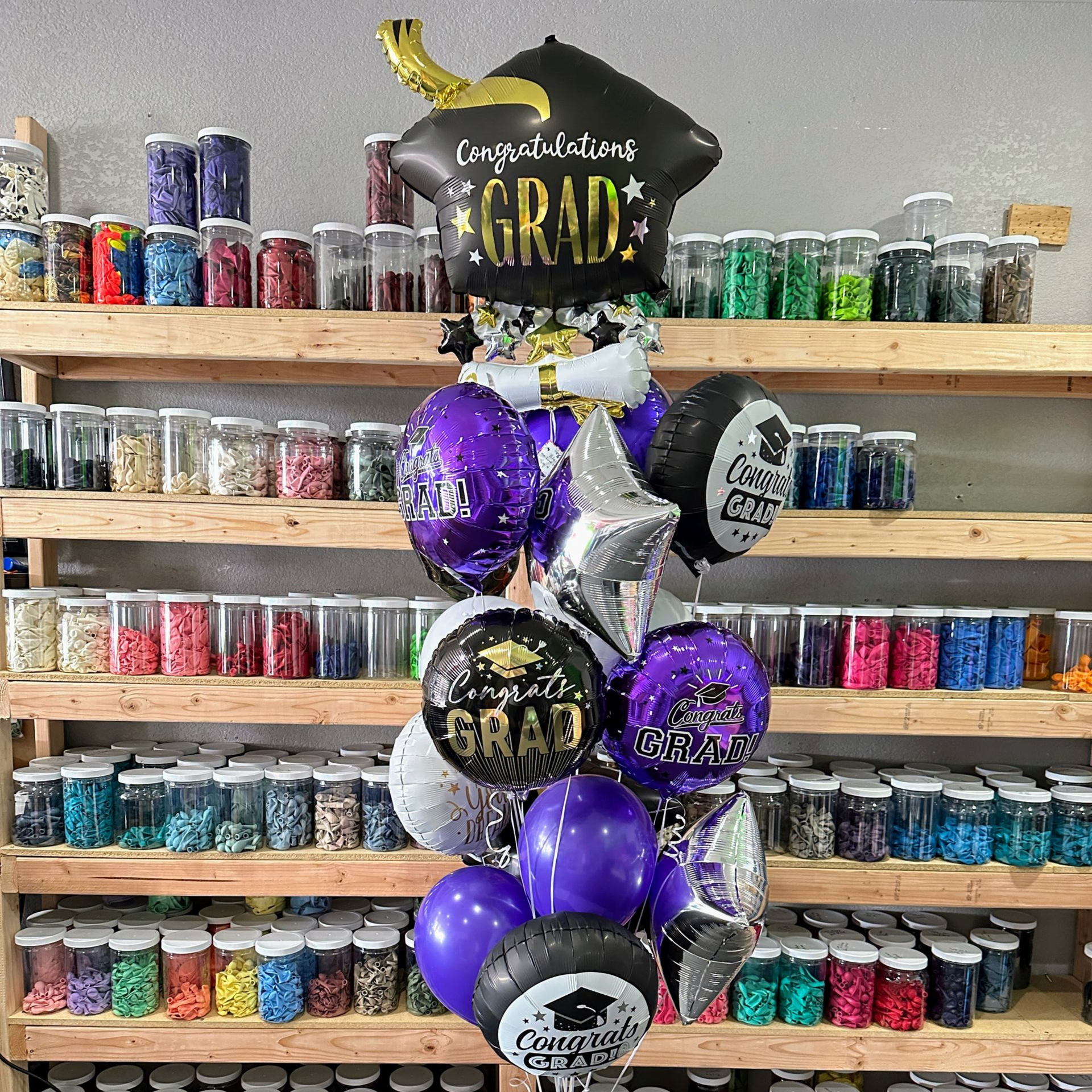 Graduation helium balloon bouquet with themed balloons for class celebration in Fort Worth DFW