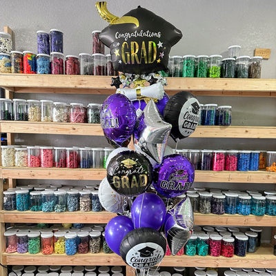 Graduation helium balloon bouquet with themed balloons for celebration and party decor in Fort Worth