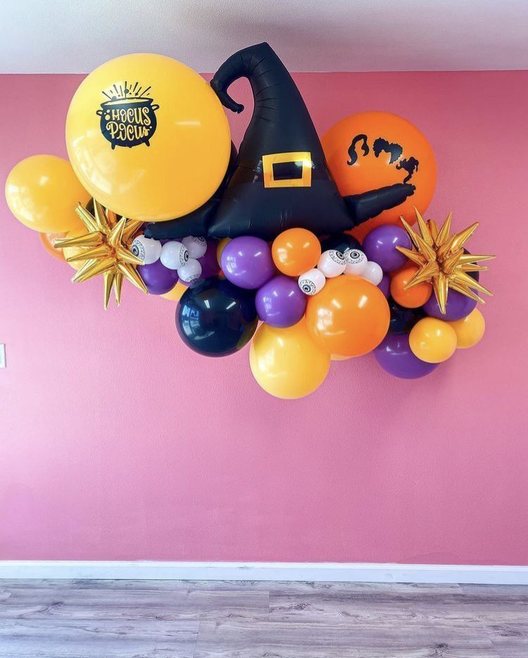 Witch theme balloon garland with assorted colors in lilac, orange, purple and black balloons with a witch hat Mylar balloon