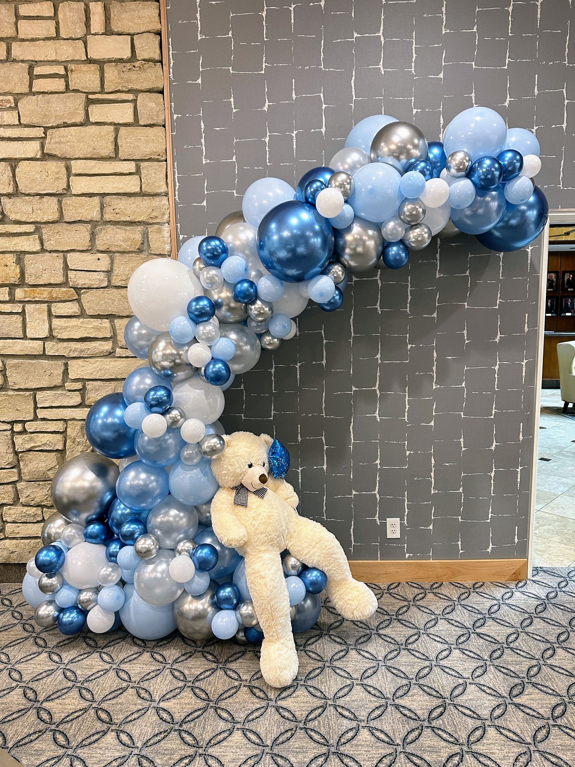 Whimsical balloon garland featuring pastel and metallic balloons styled for a playful celebration