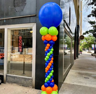 Balloon column with jumbo balloon topper and colorful spiral design for event entrance in Fort Worth