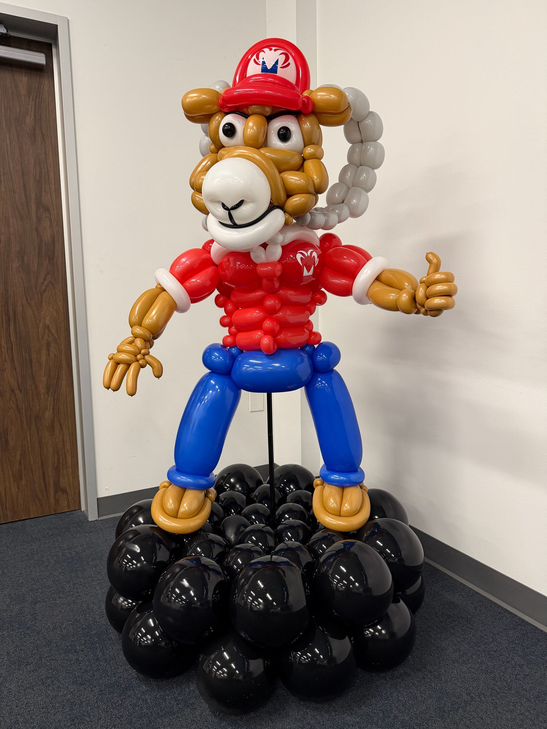 a balloon sculpture of a character mascot for an event in fort worth.
