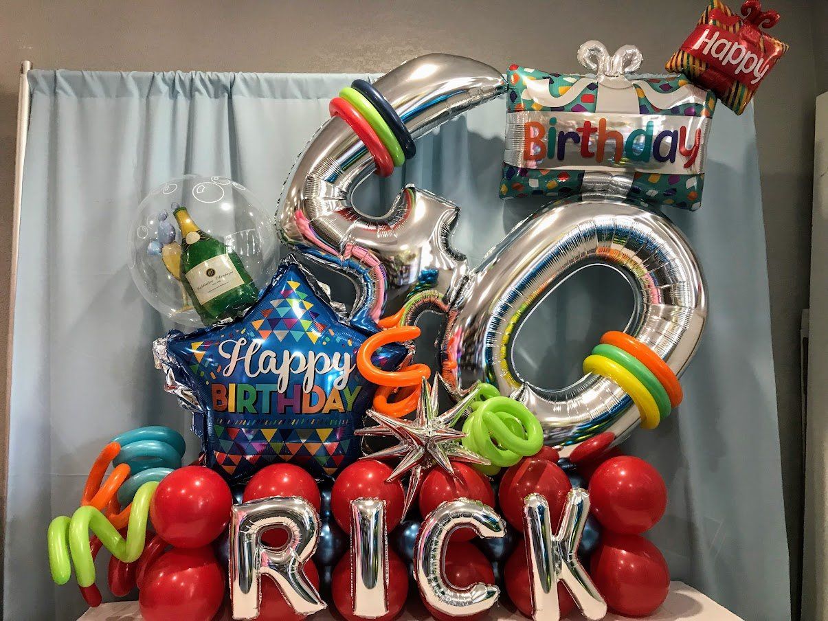 A bunch of balloons with the name rick on them
