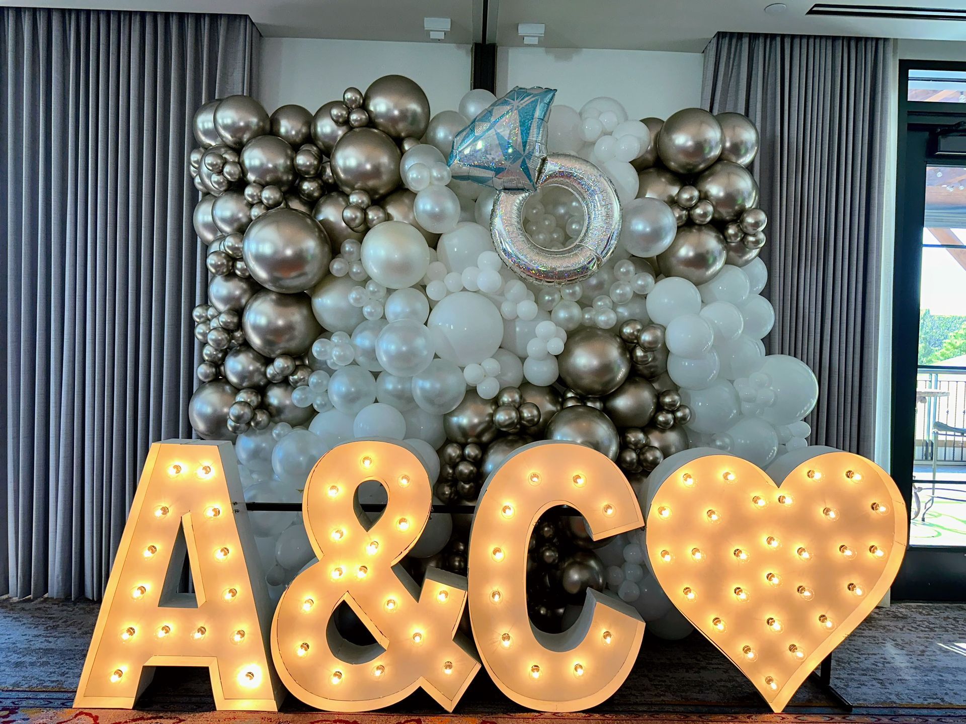 Marquee letter backdrop with balloon garland for wedding event in Fort Worth