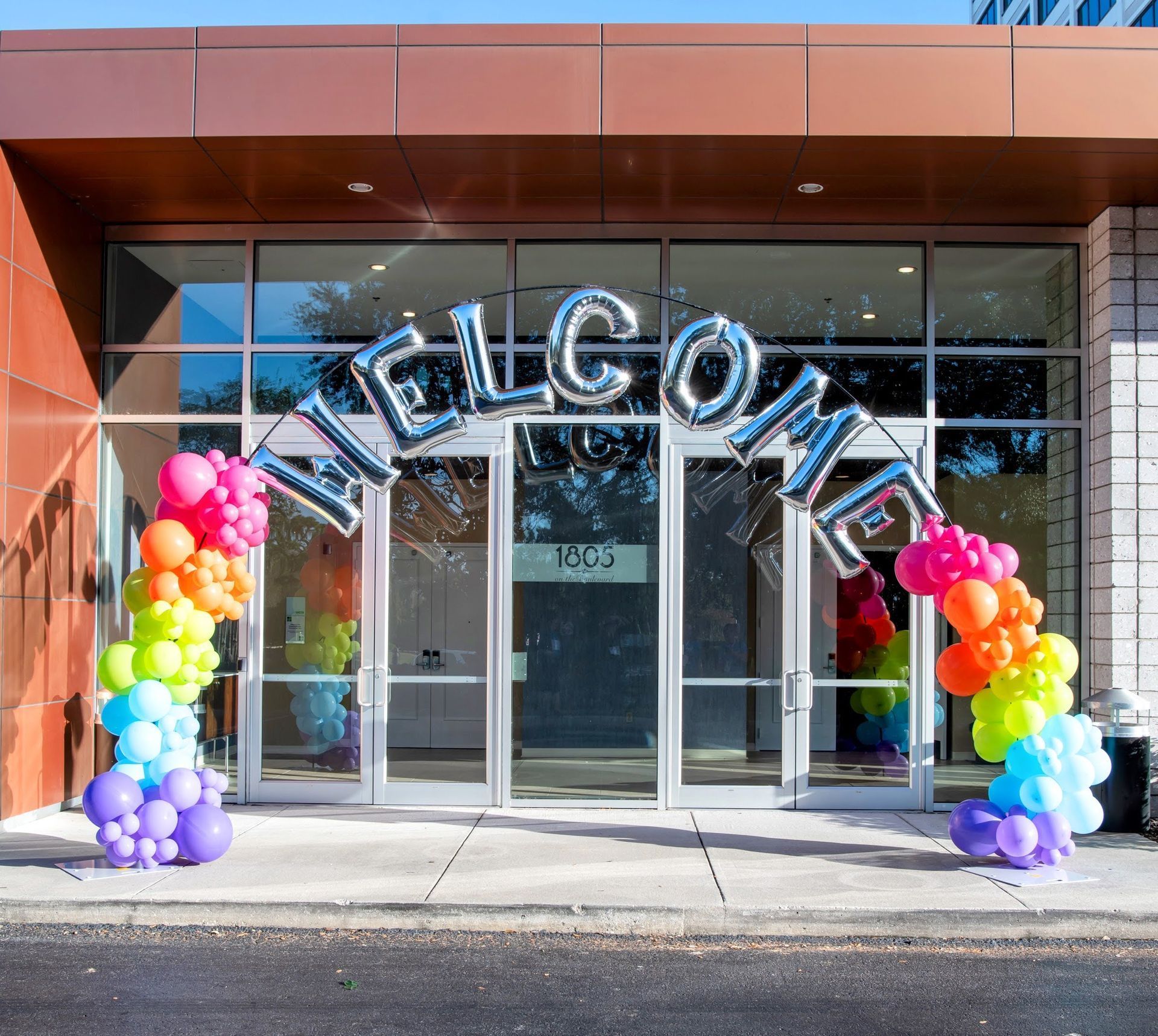 A building with balloons in front of it that says welcome