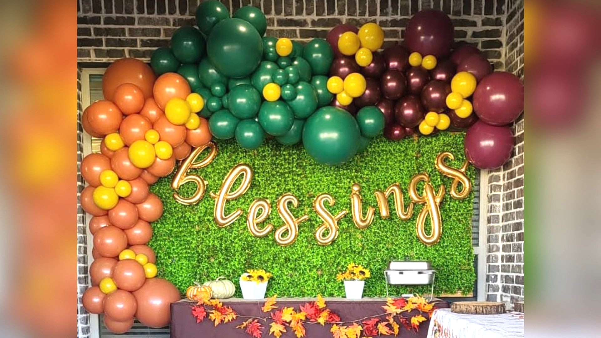 A wall decorated with balloons and a sign that says `` blessings ''.