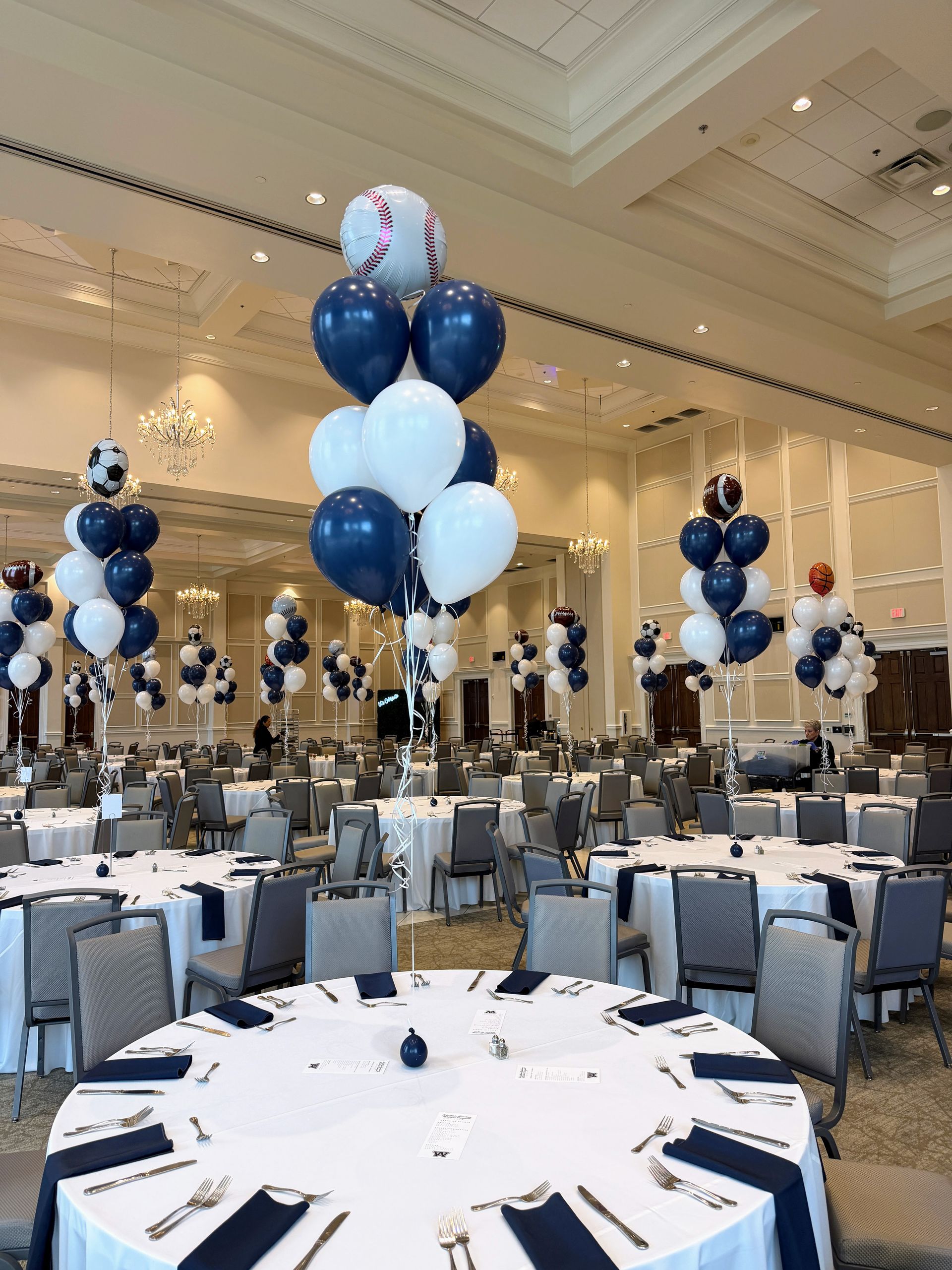 Baseball theme balloon centerpieces with navy and white helium balloons.