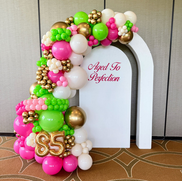 Custom birthday balloon backdrop with organic balloon garland, marquee numbers, and personalized event styling for a milestone celebration.