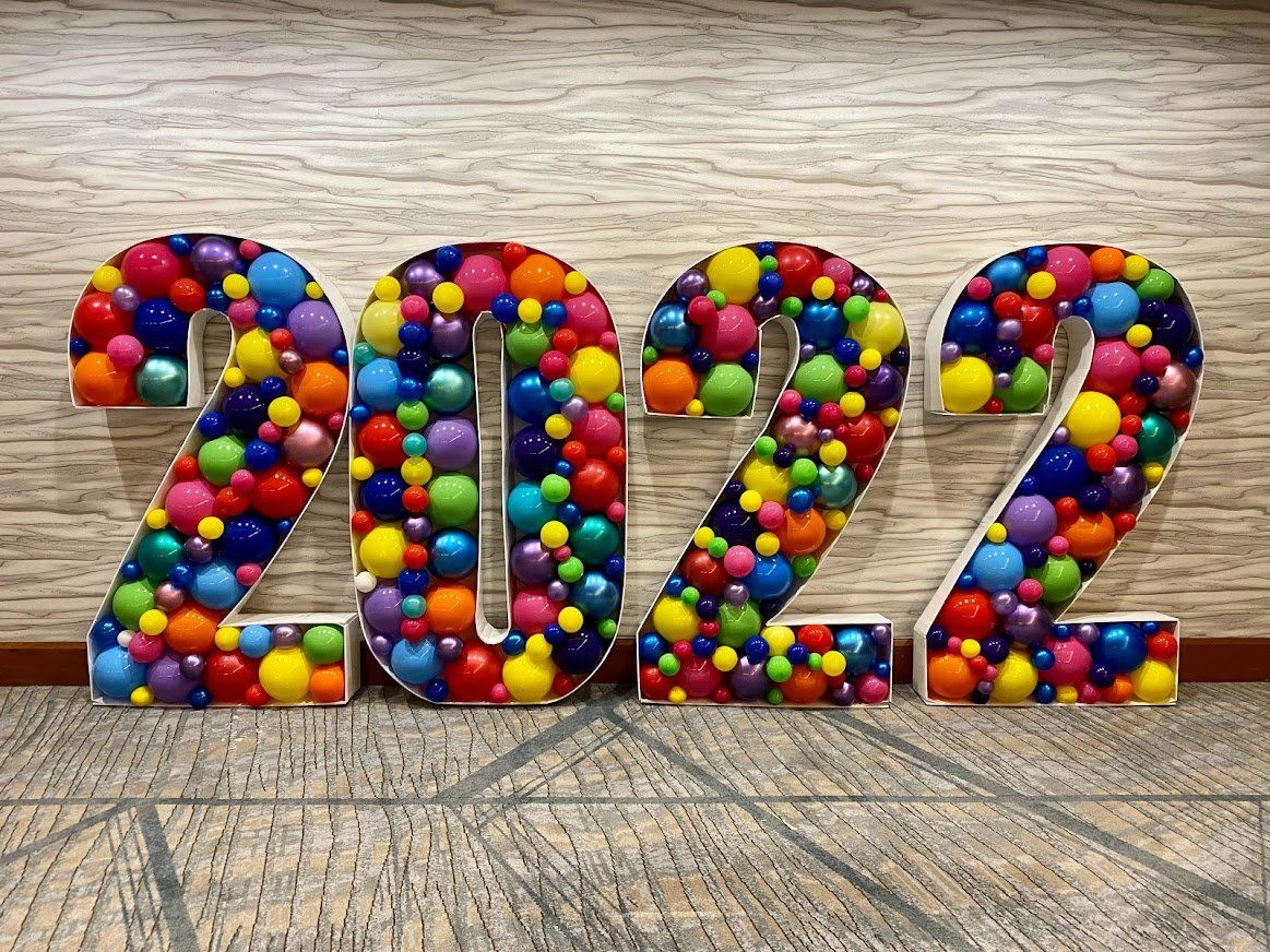 The numbers 2022 are made of colorful balloons.