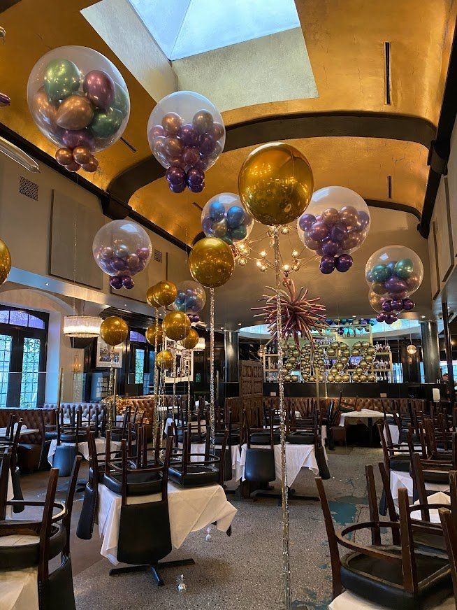 A restaurant with balloons hanging from the ceiling